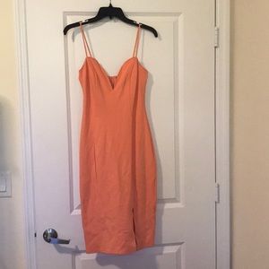 Peach midi dress with low cut front and side slit